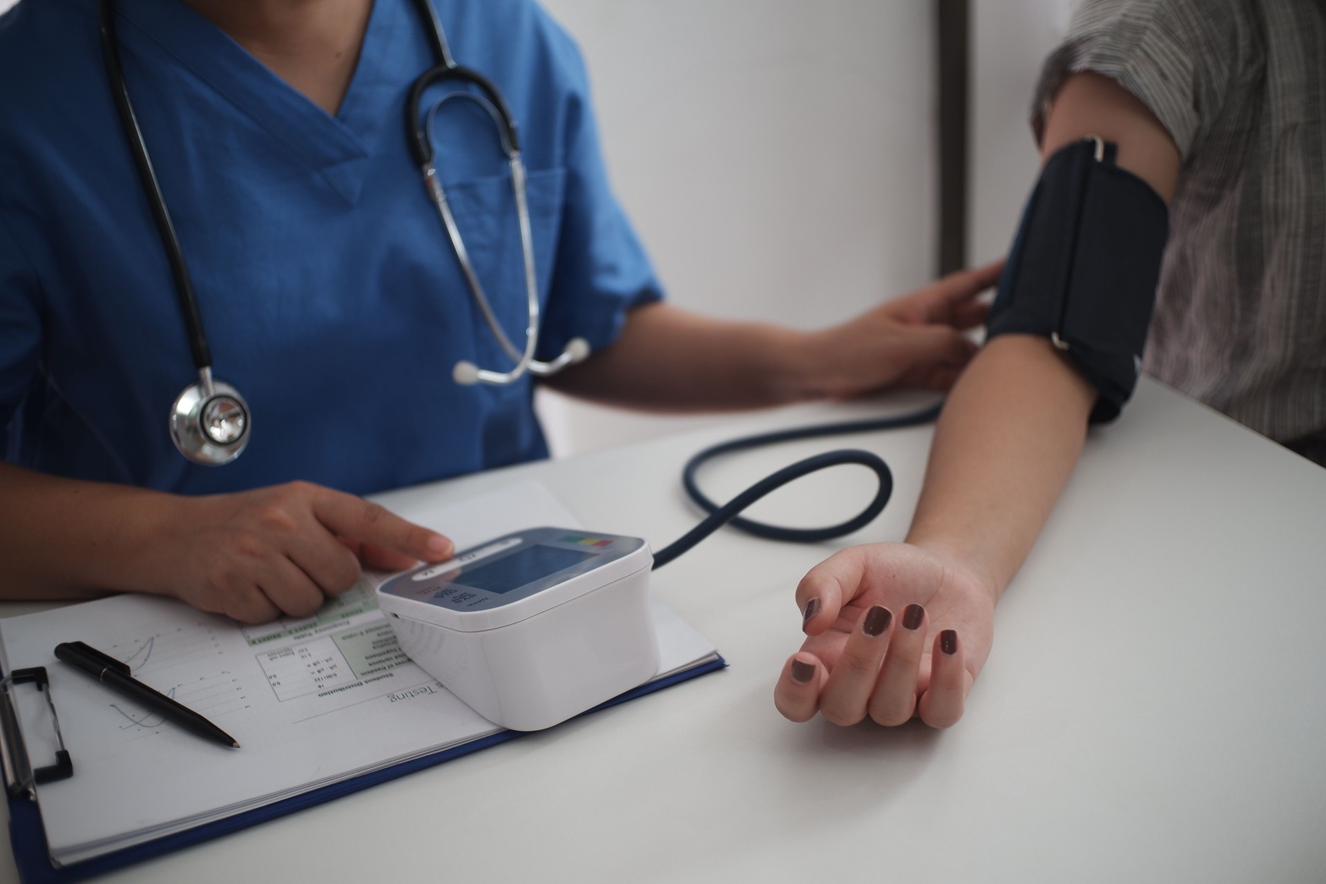 Nurse measuring blood pressure of a patient at a health check in darlington